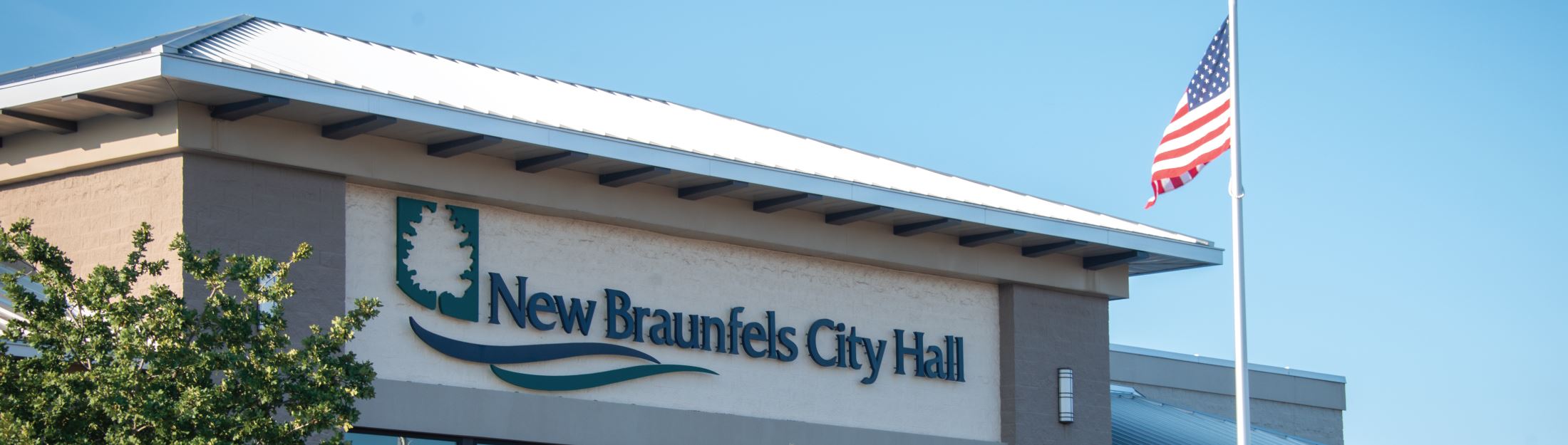 City logo displayed on the side of New Braunfels City Hall building