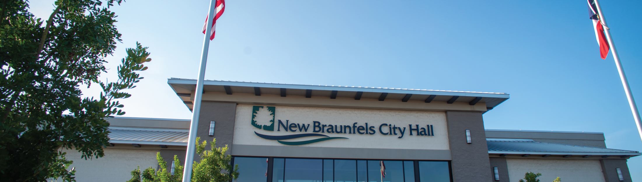 Close Up of City logo sign on top of New Braunfels City Hall