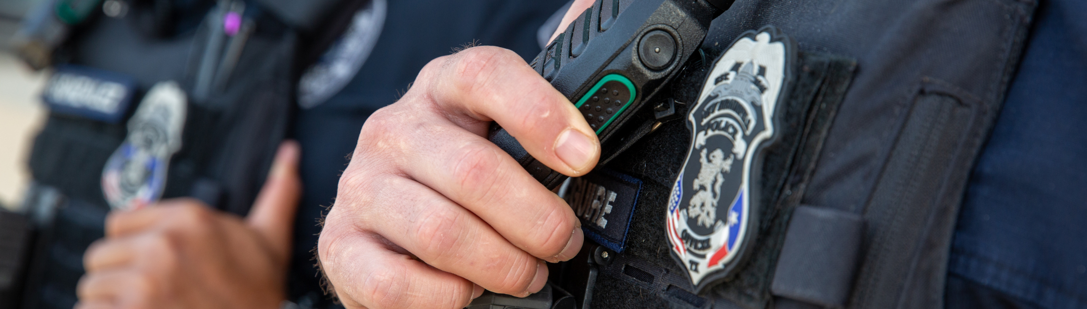 New Braunfels Police Department officer holding a radio