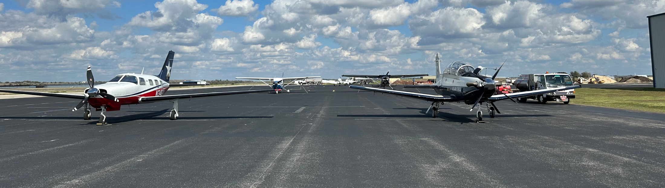 Multiple airplanes on runway at New Braunfels National Airport