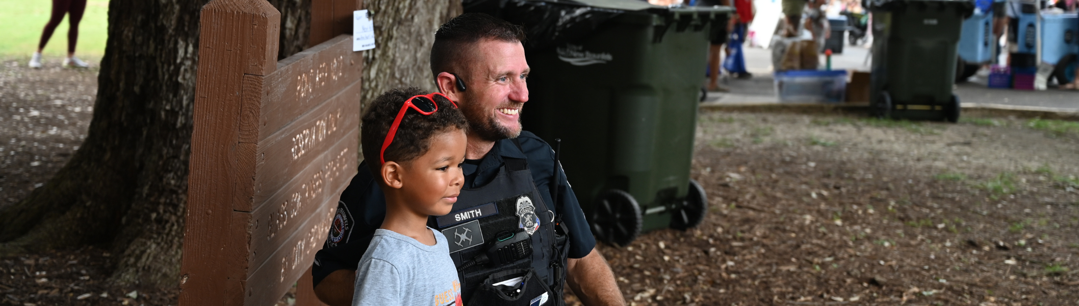 New Braunfels Police Department Police Officer standing next to a boy at a special event