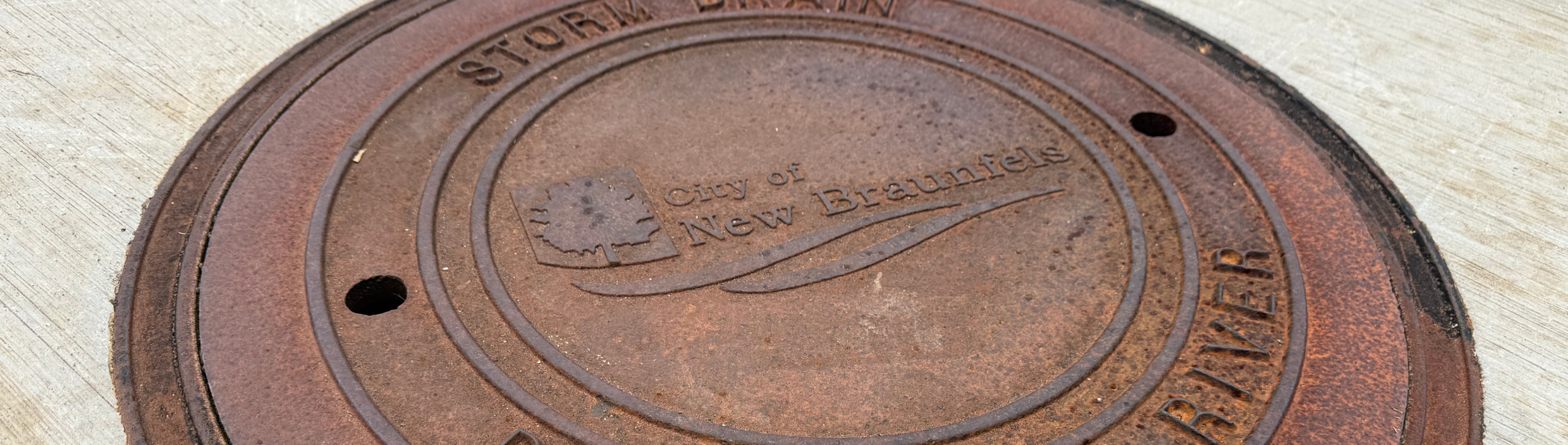 A close up view of a storm drain on the ground